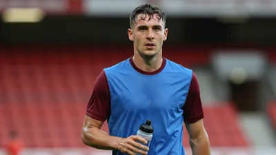 Mid-30s St Johnstone midfielder, athletic build, waist-up, intense gaze, drenched in sweat, wearing a plain blue shirt...