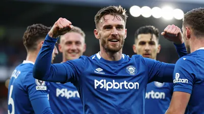 A photorealistic image of a ST Johnstone player in their blue home kit, with a white floodlight rim light, shot with a...
